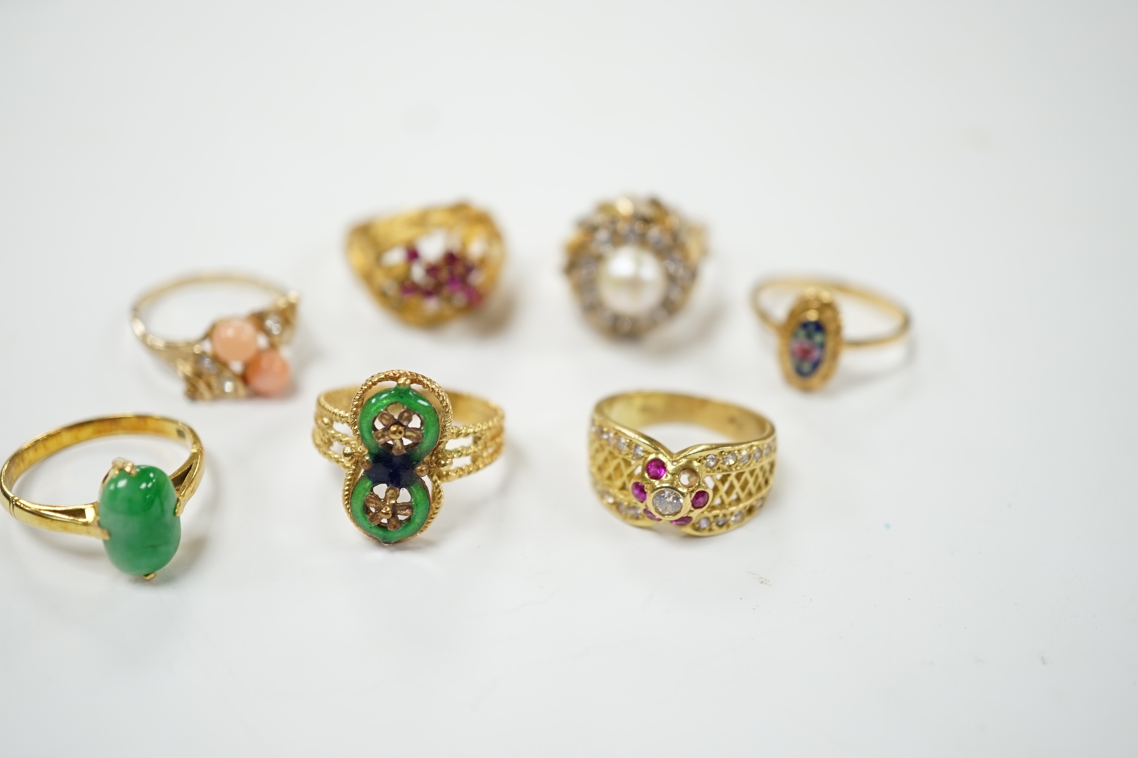 A Middle Eastern 750 yellow metal and two colour enamel up-finger ring, size M, a Chinese 750 yellow metal and gem set cluster ring, gross weight 9.4 grams, a 14k and jade set ring, gross weight 2.8 grams and three assor